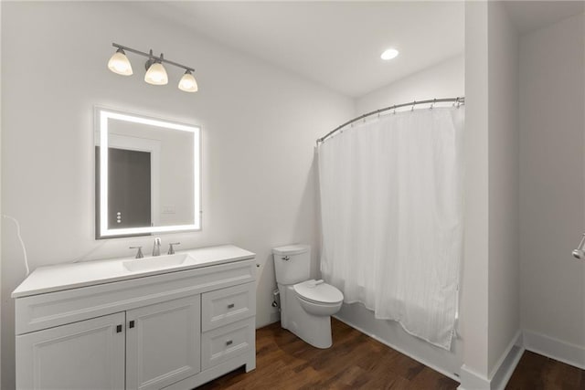 full bathroom featuring shower / bath combo, wood finished floors, vanity, and toilet