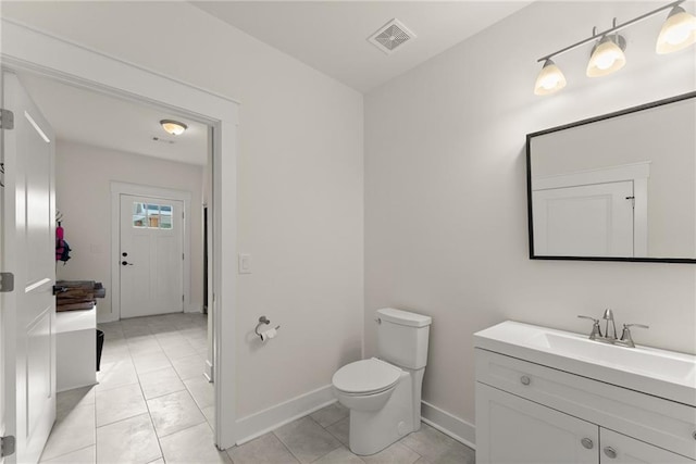 half bath with baseboards, visible vents, toilet, and vanity