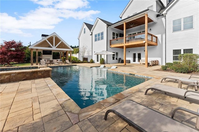 view of swimming pool featuring ceiling fan, french doors, a patio, a gazebo, and a pool with connected hot tub