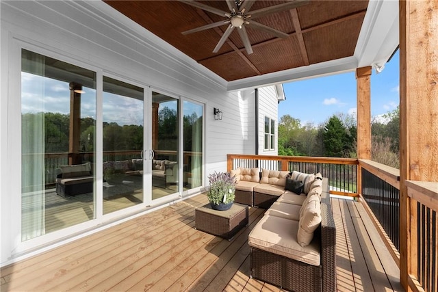 wooden deck with an outdoor living space and a ceiling fan