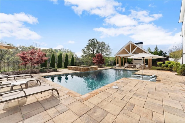 view of pool with fence, a patio area, and a pool with connected hot tub