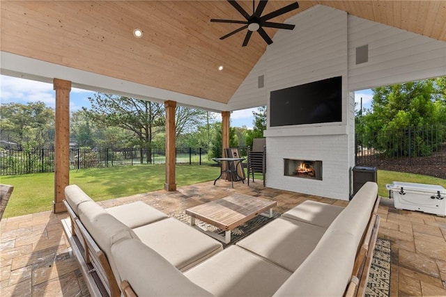 view of patio featuring an outdoor living space with a fireplace, a fenced backyard, and ceiling fan
