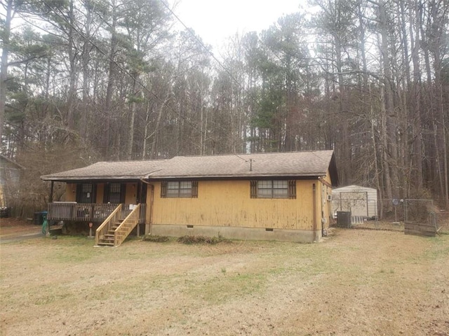 5927 Sherrie Ln, Powder Springs, GA 30127 - view of front facade featuring central AC, covered porch, a front yard, a shingled roof, and crawl space