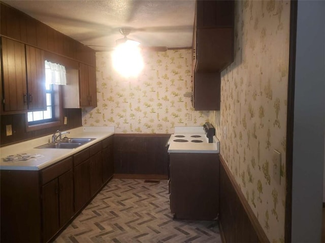 5927 Sherrie Ln, Powder Springs, GA 30127 - kitchen with a sink, light countertops, electric range oven, and wallpapered walls
