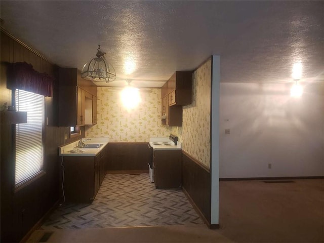5927 Sherrie Ln, Powder Springs, GA 30127 - kitchen featuring range with electric cooktop, a textured ceiling, visible vents, a sink, and baseboards