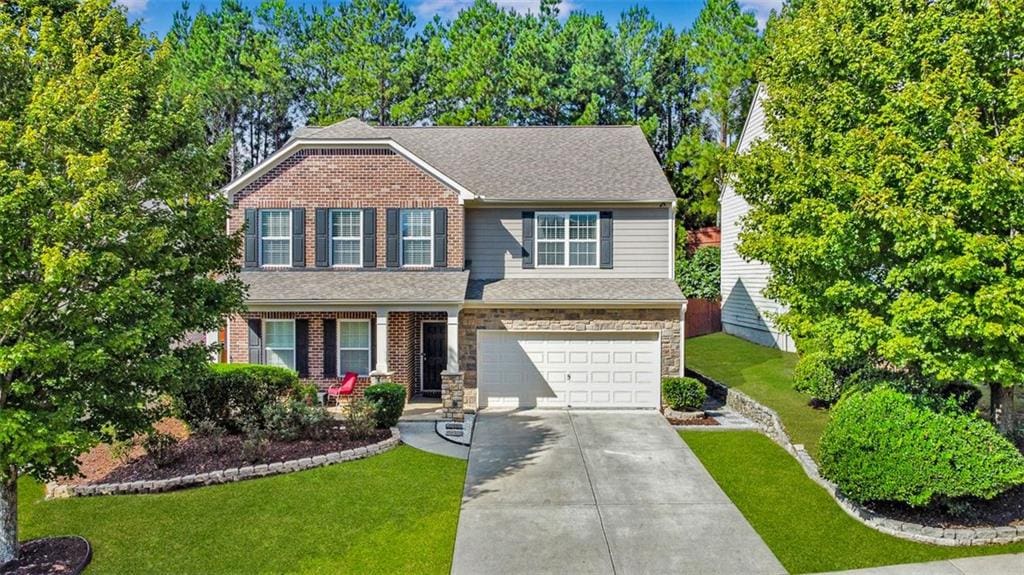 view of front of property with a garage and a front yard