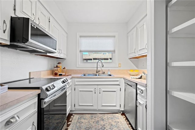 kitchen featuring white cabinets, stainless steel appliances, and sink