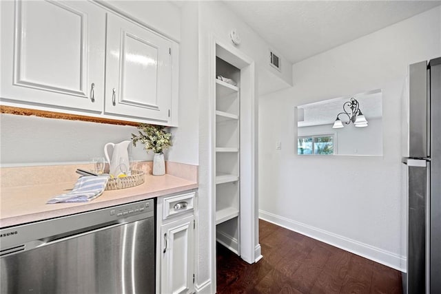 kitchen featuring appliances with stainless steel finishes, white cabinetry, and dark wood-type flooring