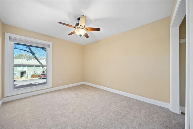 carpeted spare room with ceiling fan