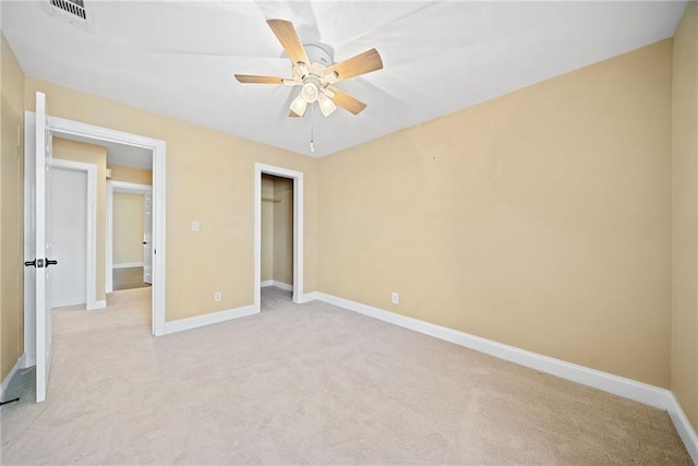 unfurnished bedroom with ceiling fan, a closet, and light carpet