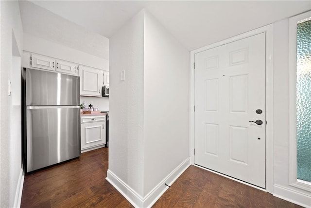 entryway with dark hardwood / wood-style flooring and lofted ceiling