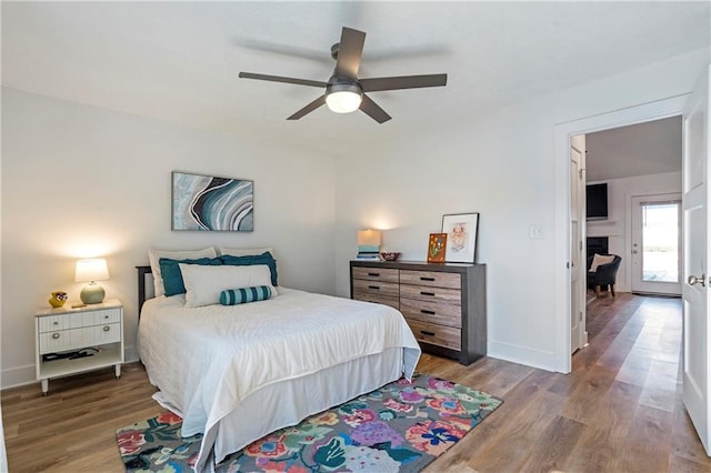 bedroom with hardwood / wood-style floors and ceiling fan