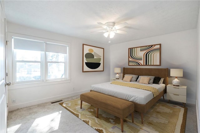 bedroom with ceiling fan and light colored carpet