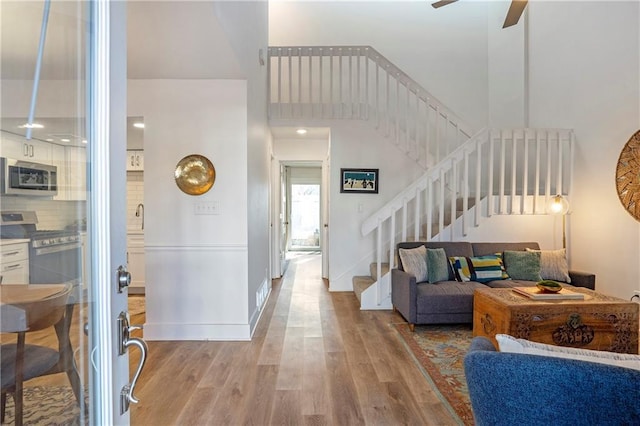 entryway featuring ceiling fan and light wood-type flooring