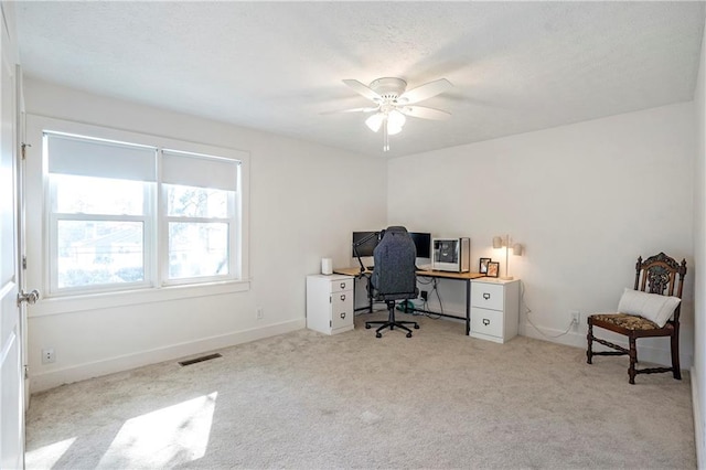 office space with ceiling fan and light colored carpet