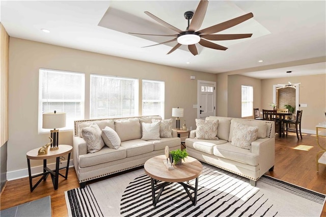 living room featuring hardwood / wood-style flooring and ceiling fan