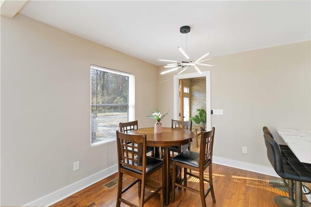 dining area with a chandelier and hardwood / wood-style floors