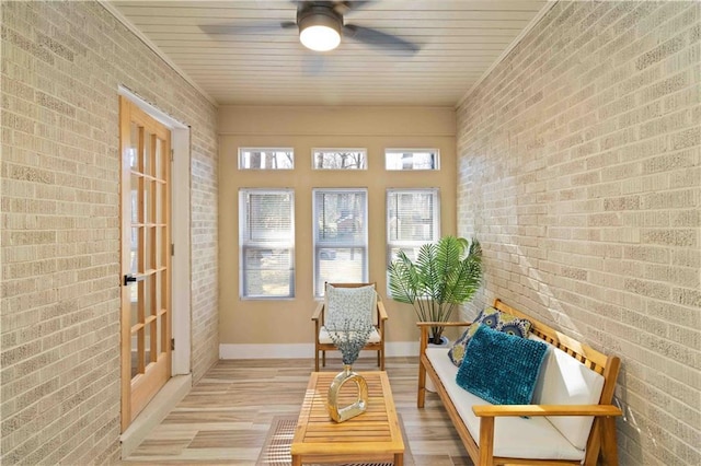 sunroom featuring ceiling fan