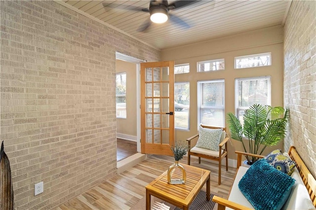 sunroom / solarium featuring wood ceiling and ceiling fan