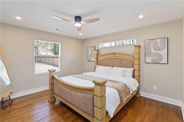 bedroom with multiple windows, dark wood-type flooring, and ceiling fan