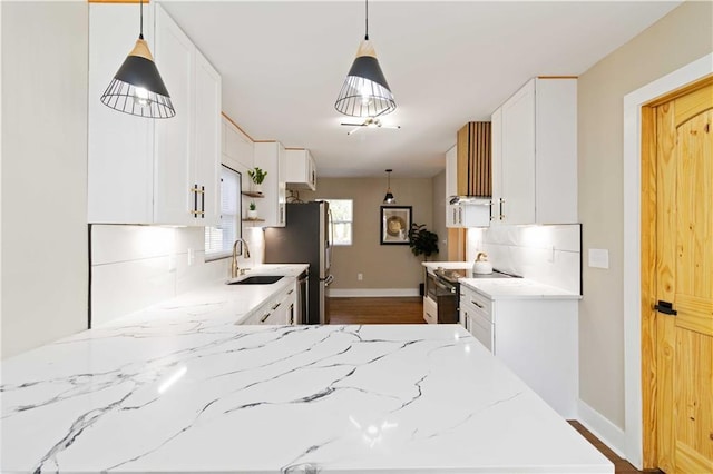 kitchen featuring white cabinetry, stainless steel electric stove, sink, and light stone counters