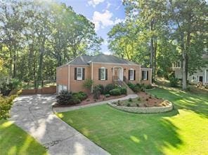 view of front facade with a garage, driveway, and a front lawn