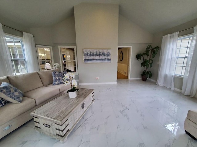 living room featuring marble finish floor, baseboards, and high vaulted ceiling