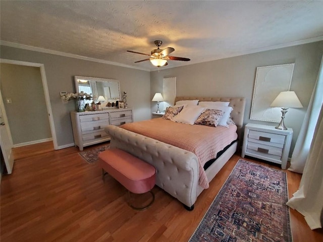 bedroom featuring light wood-style flooring, a textured ceiling, baseboards, and crown molding