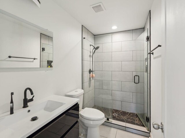 full bath with visible vents, vanity, toilet, and a shower stall