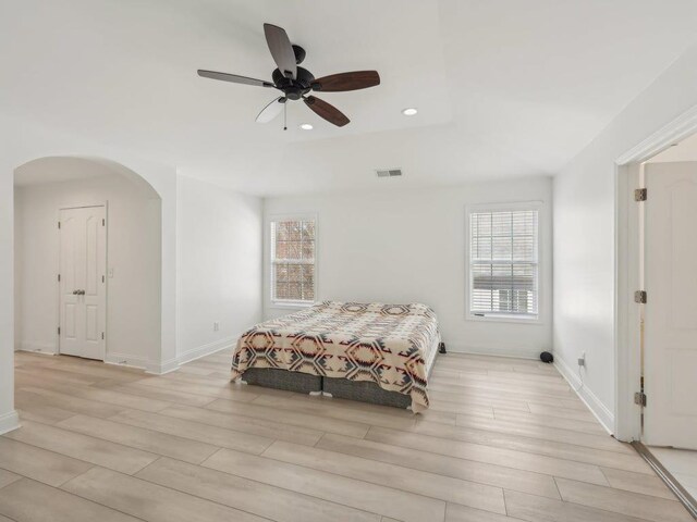bedroom featuring recessed lighting, arched walkways, visible vents, and light wood-type flooring