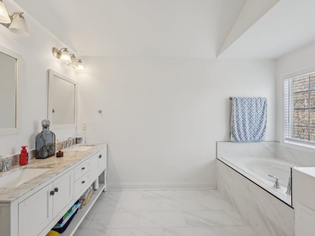 bathroom with vaulted ceiling, marble finish floor, baseboards, and a sink