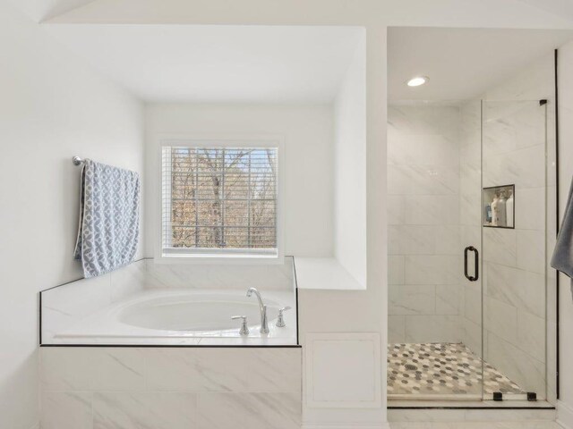 bathroom featuring a garden tub and a stall shower