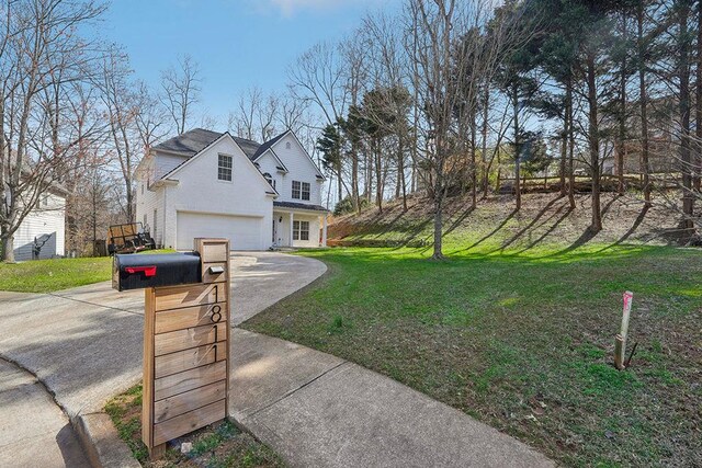 view of side of home featuring a lawn, driveway, and an attached garage