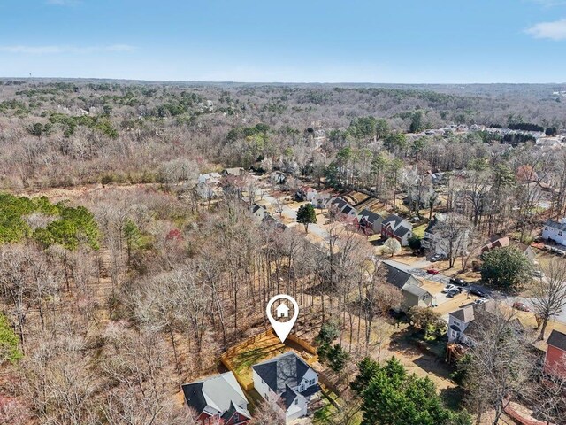 birds eye view of property with a forest view