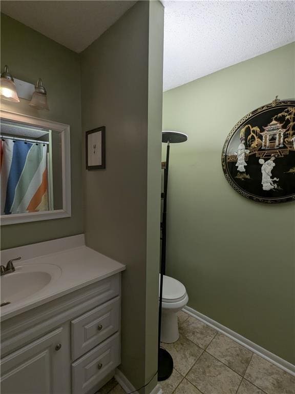 bathroom with tile patterned floors, toilet, and vanity