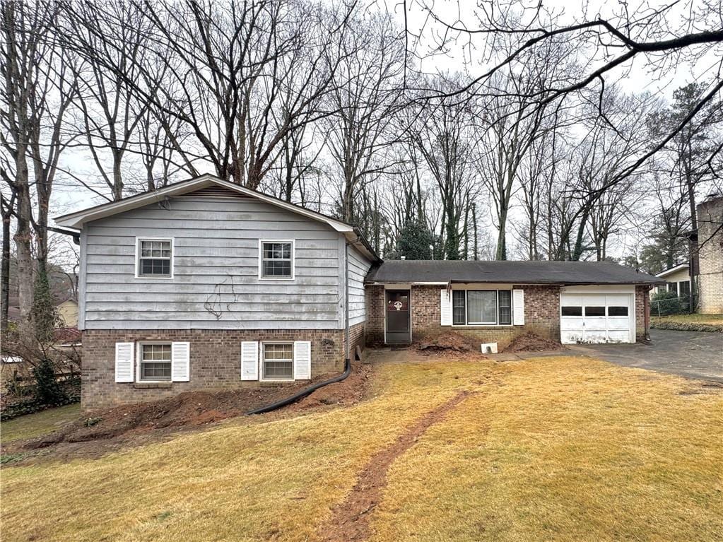 split level home featuring a garage and a front yard