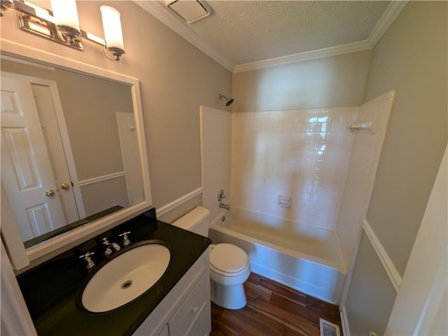 full bathroom with hardwood / wood-style floors, ornamental molding, vanity, tub / shower combination, and a textured ceiling