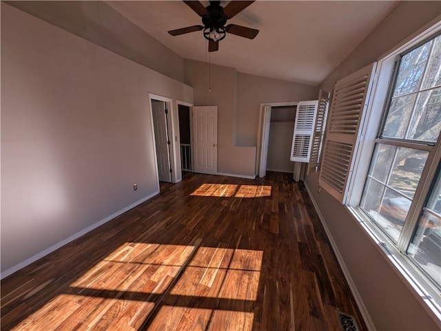 unfurnished bedroom with vaulted ceiling, dark wood-type flooring, and ceiling fan