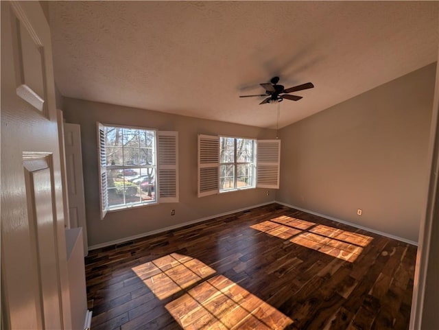 spare room with ceiling fan, dark hardwood / wood-style floors, and a textured ceiling