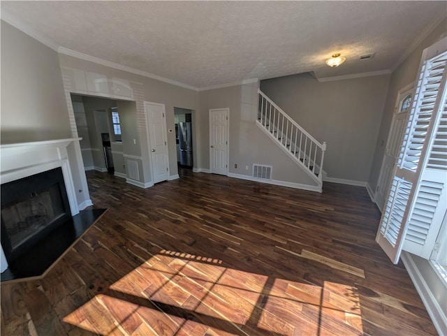 unfurnished living room featuring dark hardwood / wood-style flooring, crown molding, and a textured ceiling