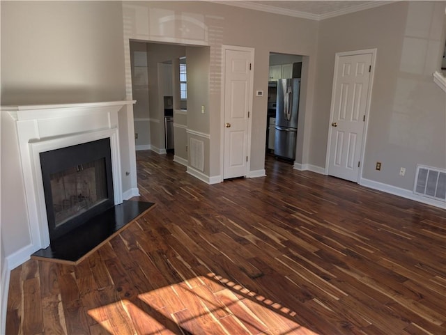 unfurnished living room featuring crown molding and dark hardwood / wood-style flooring