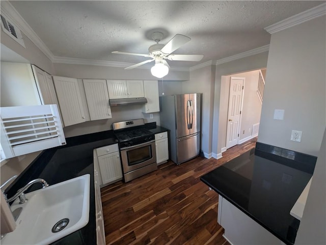 kitchen featuring appliances with stainless steel finishes, sink, white cabinets, and a textured ceiling