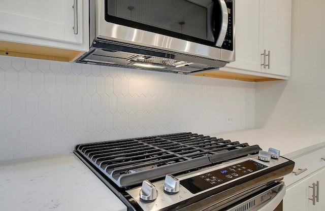 details featuring white cabinetry and appliances with stainless steel finishes