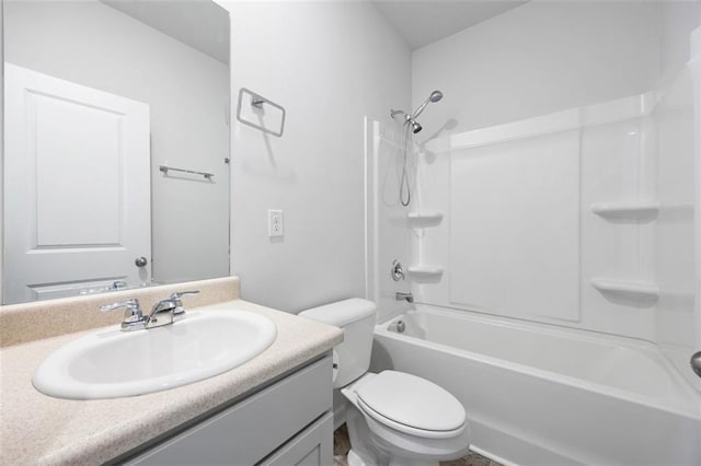 full bathroom with toilet, vanity, and washtub / shower combination