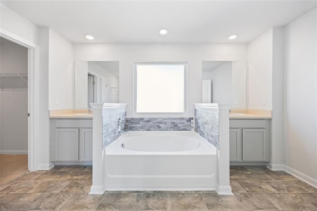 bathroom featuring a bathing tub and vanity