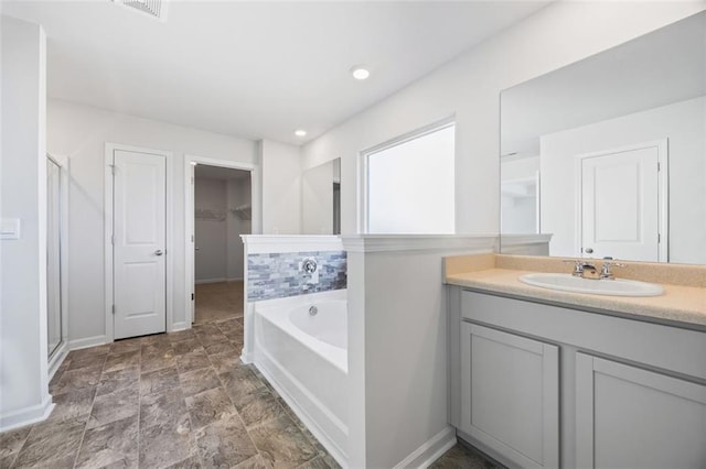 bathroom featuring vanity and shower with separate bathtub