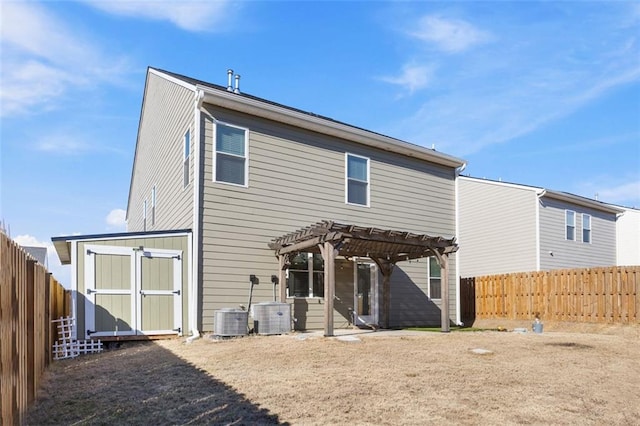 back of house featuring a shed, central AC unit, and a pergola