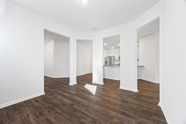 unfurnished living room featuring dark wood-type flooring