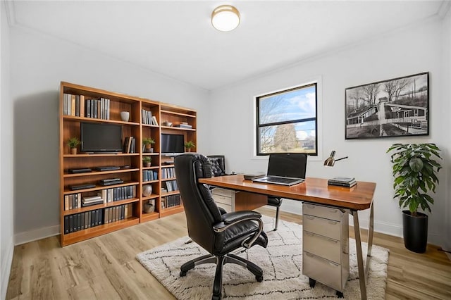 office area with ornamental molding, wood finished floors, and baseboards