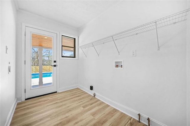laundry room with washer hookup, light wood finished floors, and baseboards